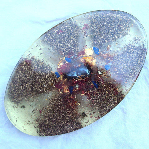 Oval orgone charging plate with hematite.